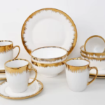 16-piece white ceramic dinner set featuring a luxury drip-effect gold trim