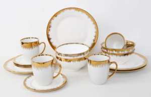 16-piece white ceramic dinner set featuring a luxury drip-effect gold trim